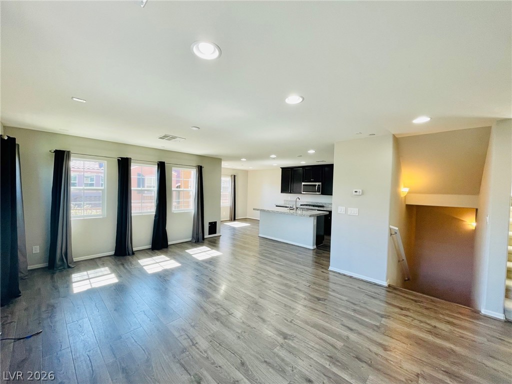 9921 Sable Point Street Las Vegas, NV 89178 - Photo 42 of 43 Polished wood-style LVP flooring flows seamlessly across a generous open floorplan designed for modern living.
