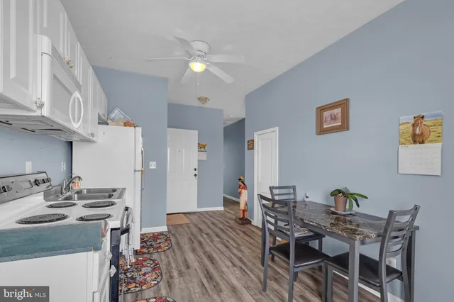 a bathroom with a sink a stove and cabinets
