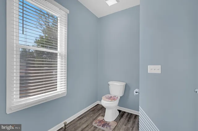 a bedroom with a bed a dresser and chair