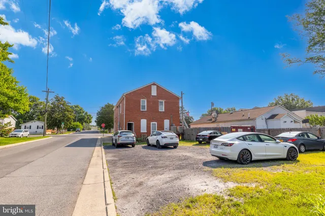 a view of cars parked in front of a house