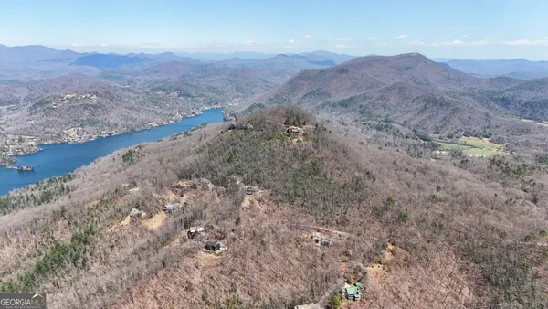a view of a dry yard with wooden fence