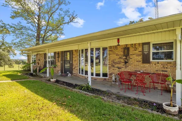 a view of a house with backyard porch and sitting area