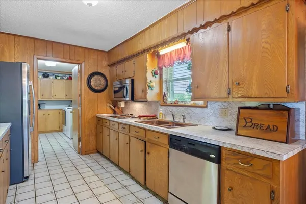 a kitchen with a sink and a stove top oven