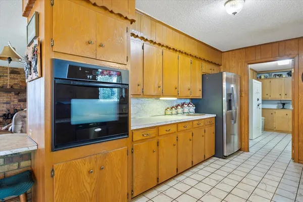 a kitchen with stainless steel appliances a stove a refrigerator and cabinets