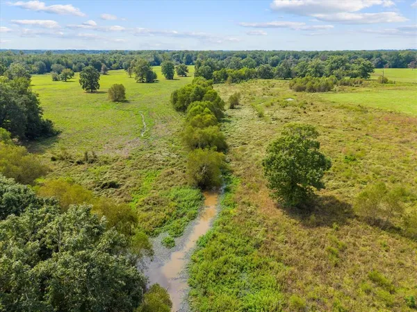a view of a lake with houses in the back