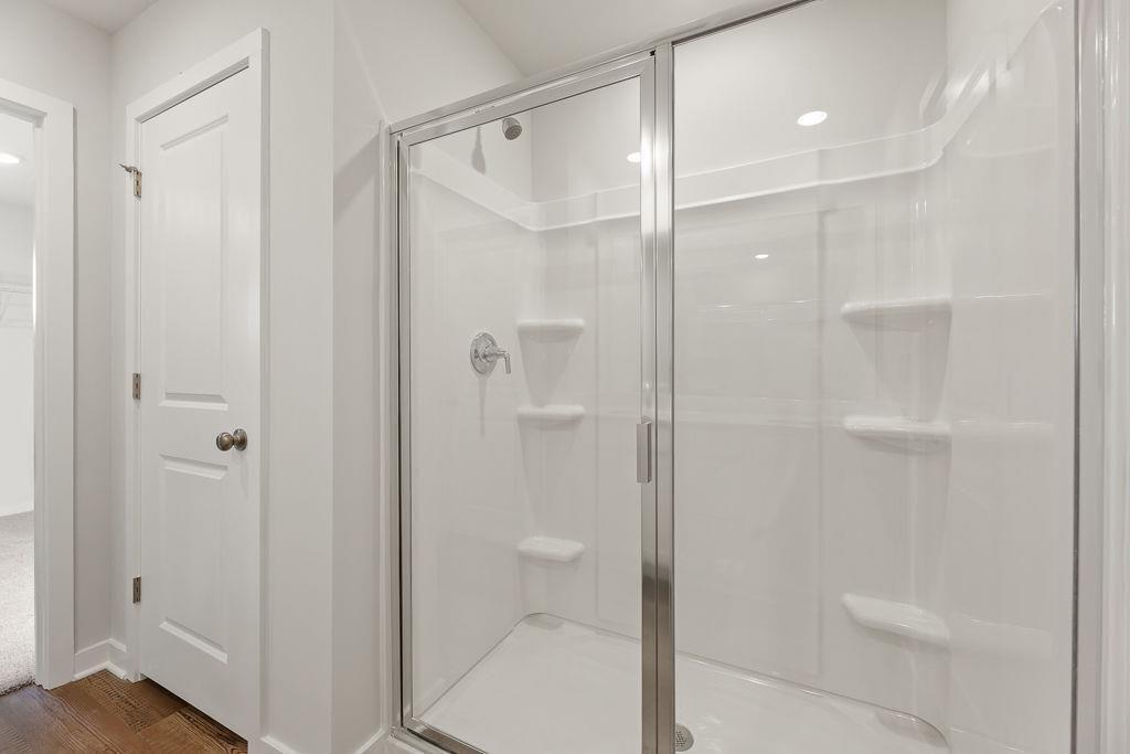 542 Arborston Way Jefferson, GA 30549 - Photo 11 of 28 a bathroom with a glass shower door