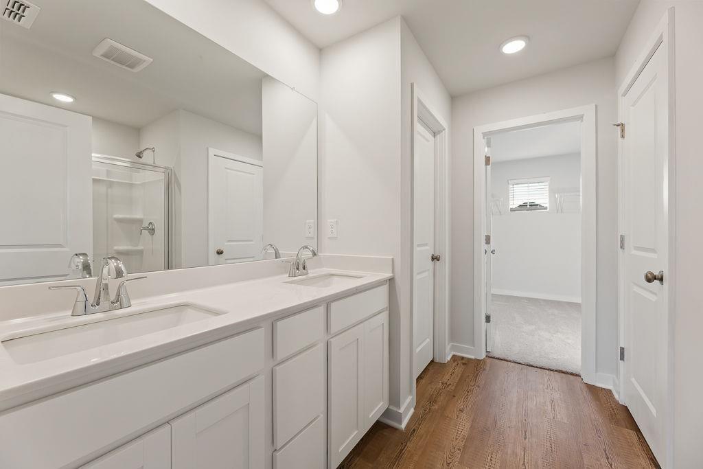 542 Arborston Way Jefferson, GA 30549 - Photo 12 of 28 a bathroom with a double vanity sink and mirror