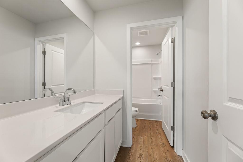 542 Arborston Way Jefferson, GA 30549 - Photo 16 of 28 a bathroom with a sink a toilet and shower