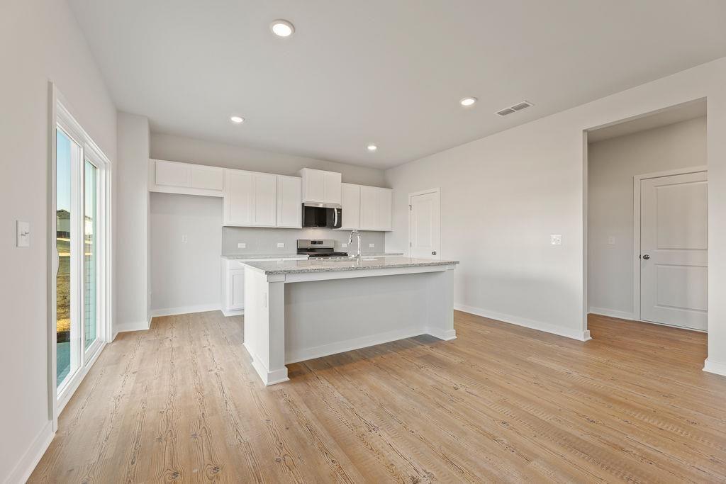 542 Arborston Way Jefferson, GA 30549 - Photo 25 of 28 a view of kitchen with cabinets and wooden floor