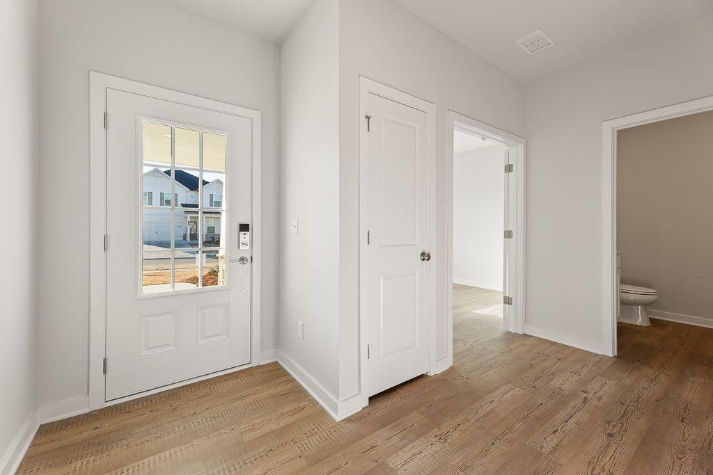 542 Arborston Way Jefferson, GA 30549 - Photo 4 of 28 a view of an empty room with wooden floor and a window