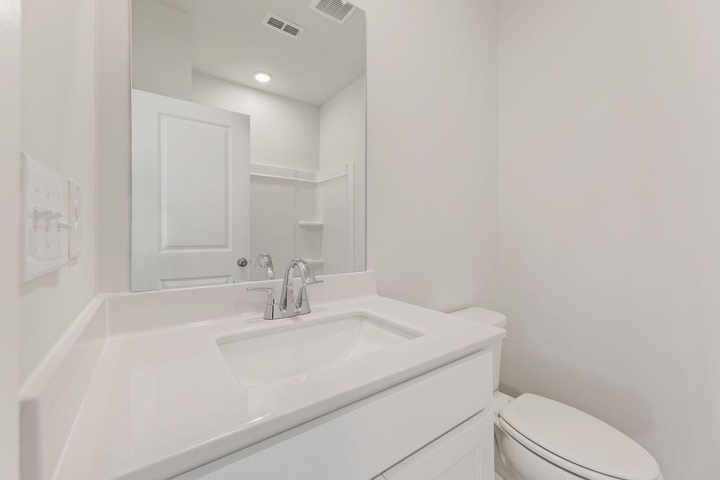 542 Arborston Way Jefferson, GA 30549 - Photo 7 of 28 a bathroom with a sink a toilet and a mirror