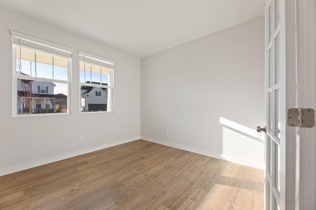 542 Arborston Way Jefferson, GA 30549 - Photo 9 of 28 a view of an empty room with a window and wooden floor