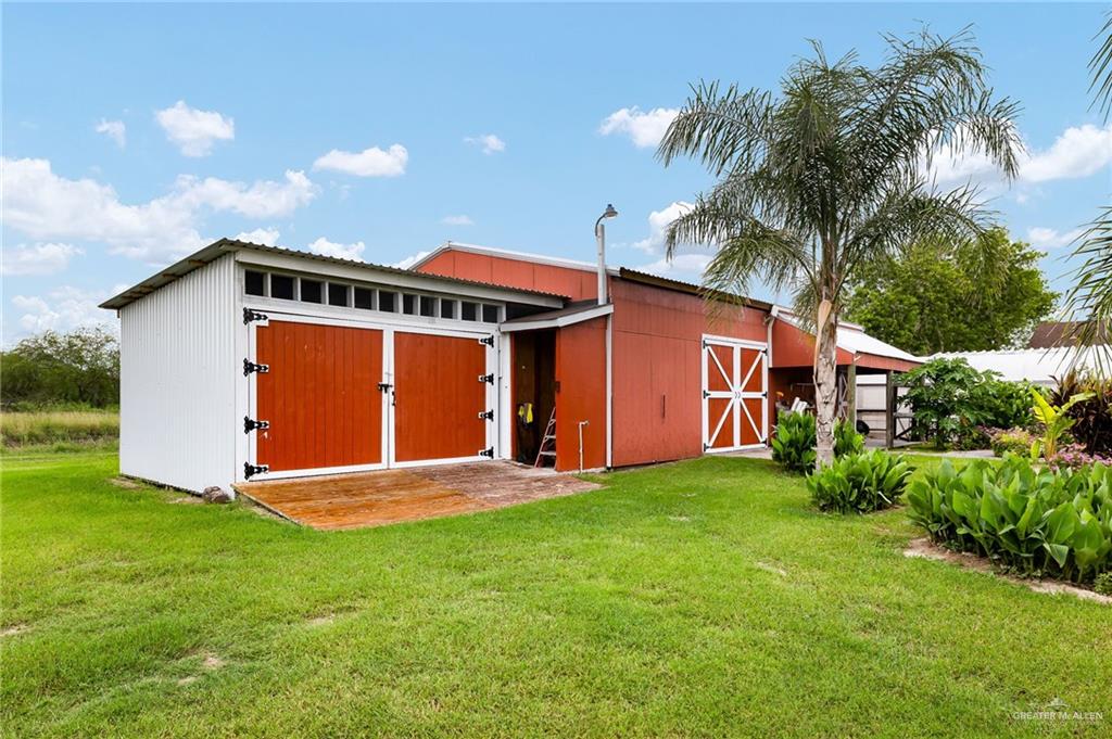 22172 North Olmito Road Rio Hondo, TX 78583 - Photo 29 of 33 a front view of a house with a yard and palm trees