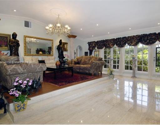 1580 Cleveland Road Miami Beach, FL 33141 - Photo 3 of 8 a living room with furniture and a chandelier