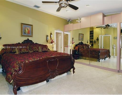 1580 Cleveland Road Miami Beach, FL 33141 - Photo 5 of 8 a bedroom with a bed dresser and a ceiling fan