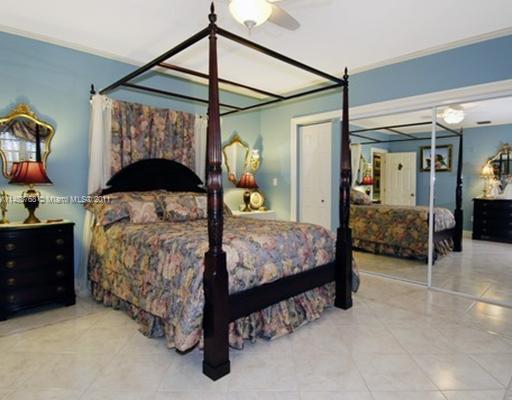 1580 Cleveland Road Miami Beach, FL 33141 - Photo 7 of 8 a bedroom with a bed and a table