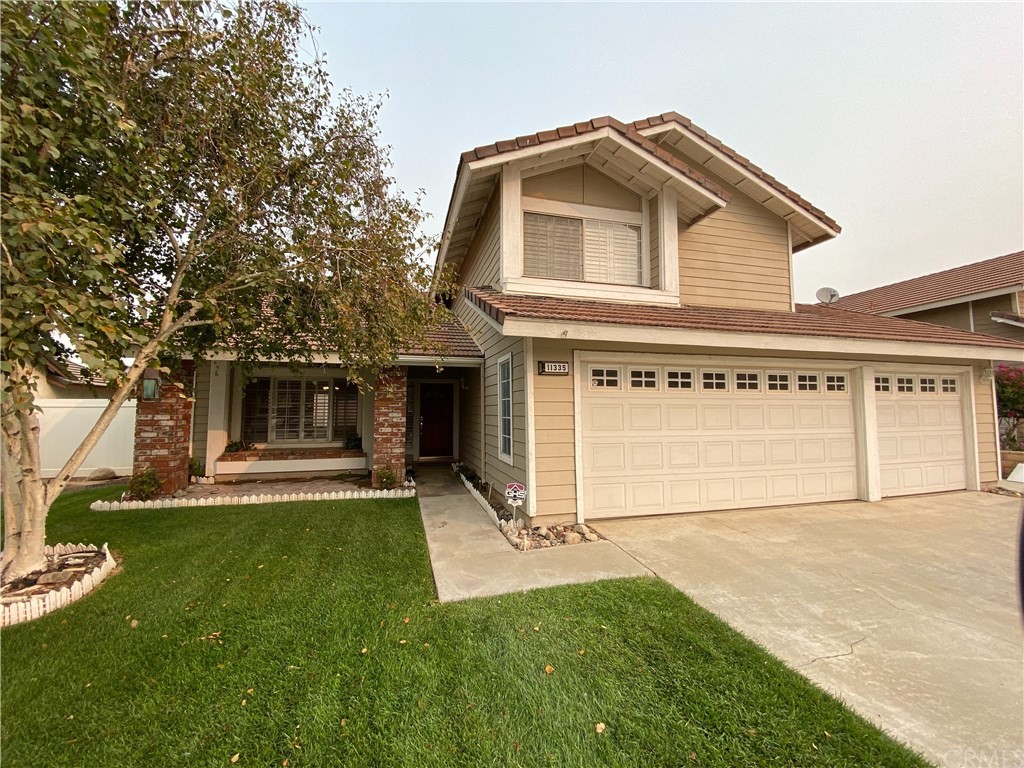 11335 Rancho Del Oro Drive Riverside, CA 92505 - Photo 1 of 1 a front view of a house with a yard and garage