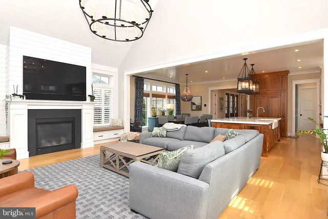 a living room with furniture and large windows