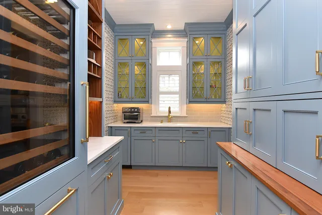 a bathroom with a granite countertop toilet sink and mirror