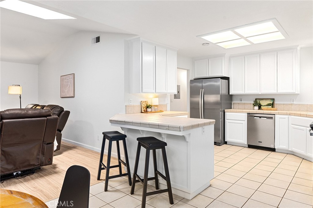 3011 Calistoga Drive Chico, CA 95973 - Photo 12 of 40 a kitchen with a table chairs refrigerator and microwave