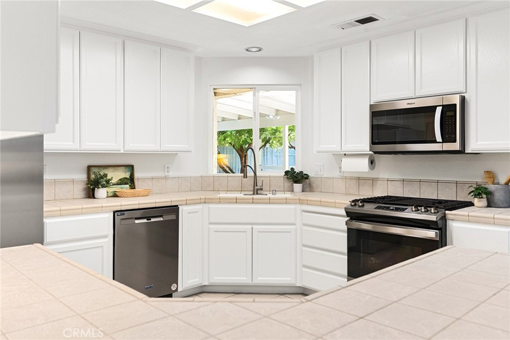 3011 Calistoga Drive Chico, CA 95973 - Photo 14 of 40 a kitchen with cabinets stainless steel appliances and a window