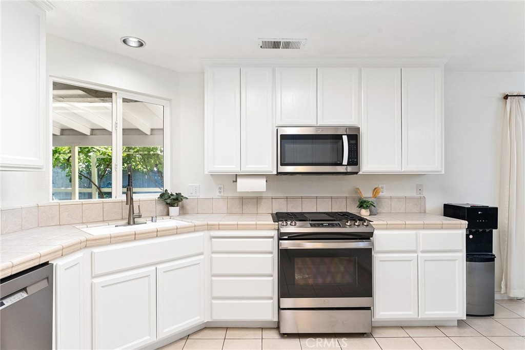3011 Calistoga Drive Chico, CA 95973 - Photo 15 of 40 a kitchen with white cabinets appliances and a window