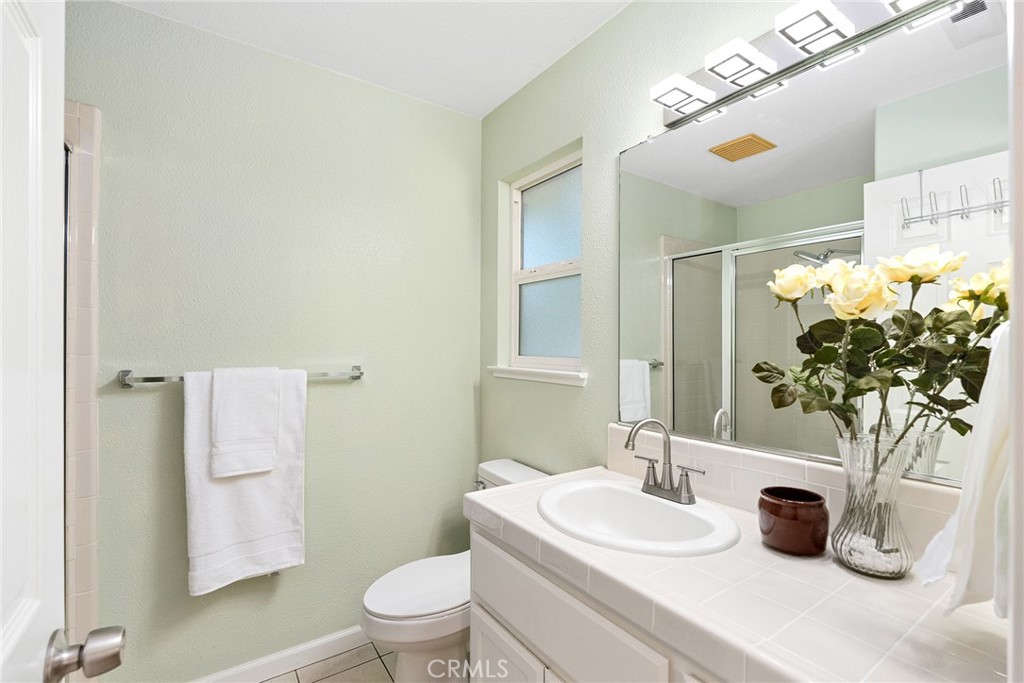 3011 Calistoga Drive Chico, CA 95973 - Photo 19 of 40 a bathroom with a sink a toilet and a mirror