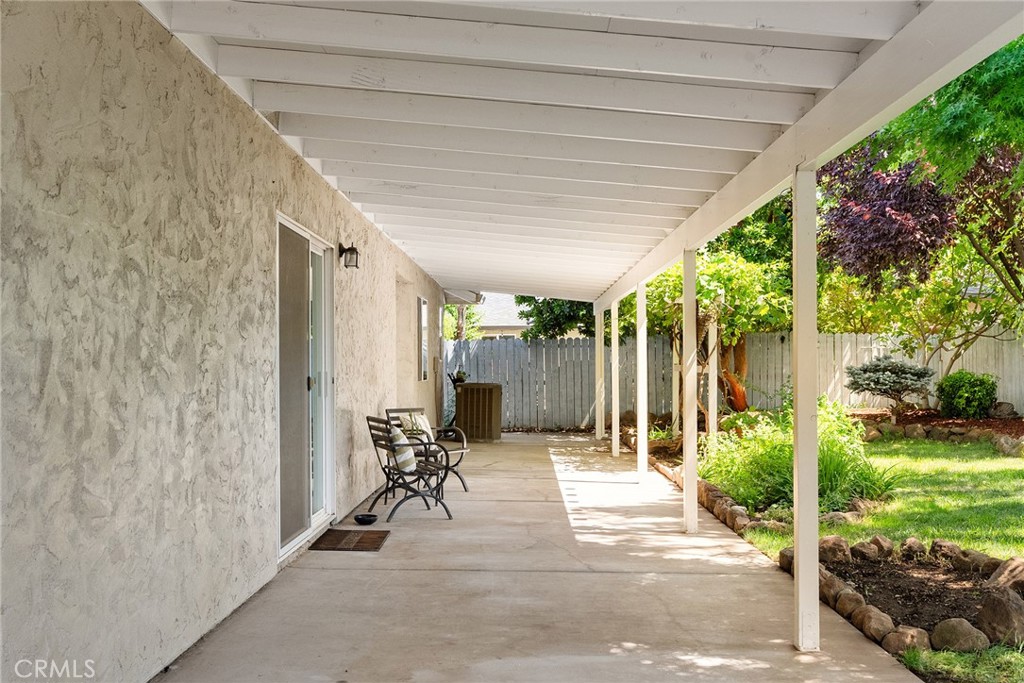 3011 Calistoga Drive Chico, CA 95973 - Photo 28 of 40 a view of a patio with table and chairs floor to ceiling window and yard
