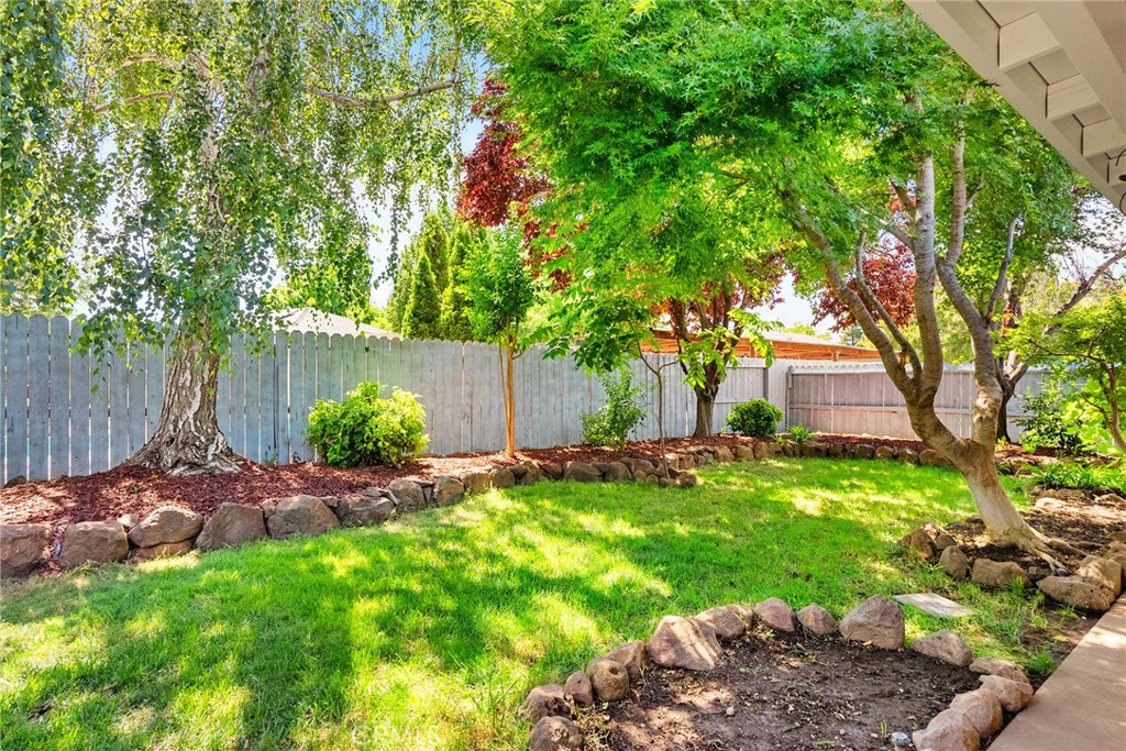 3011 Calistoga Drive Chico, CA 95973 - Photo 32 of 40 a backyard of a house with table and chairs plants and large tree