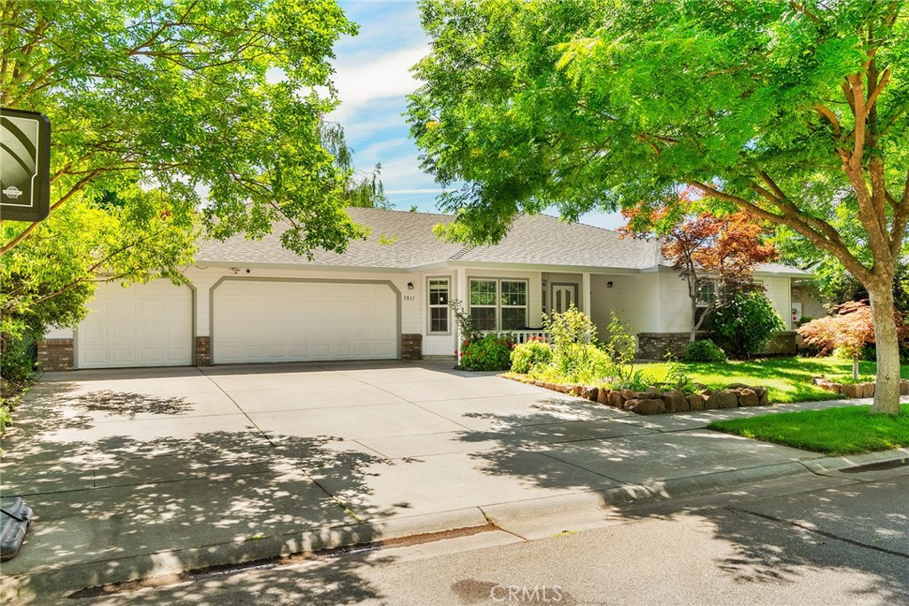 3011 Calistoga Drive Chico, CA 95973 - Photo 38 of 40 a front view of a house with a yard and potted plants