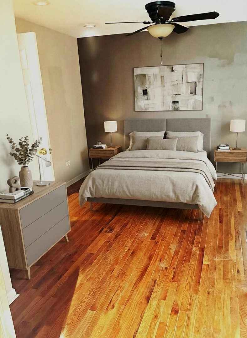 12346 South Indiana Avenue Chicago, IL 60628 - Photo 3 of 14 a bedroom with a bed and wooden floor