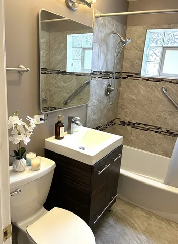 a bathroom with a sink mirror vanity and toilet