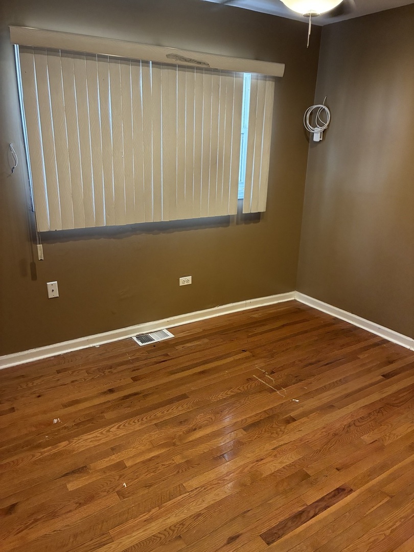 12346 South Indiana Avenue Chicago, IL 60628 - Photo 8 of 14 a view of a room with wooden floor and a window