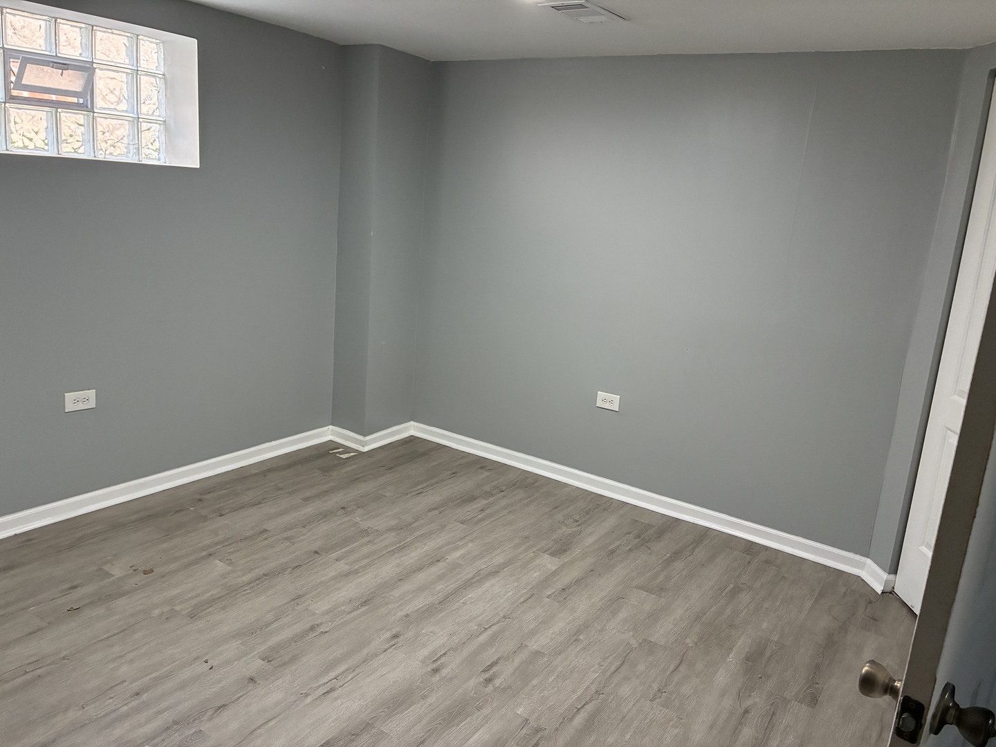 12346 South Indiana Avenue Chicago, IL 60628 - Photo 10 of 14 a view of an empty room with wooden floor and a window