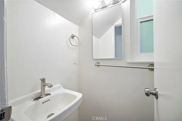 a bathroom with a sink and mirror