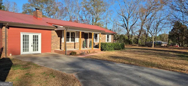 a view of a house with a large tree