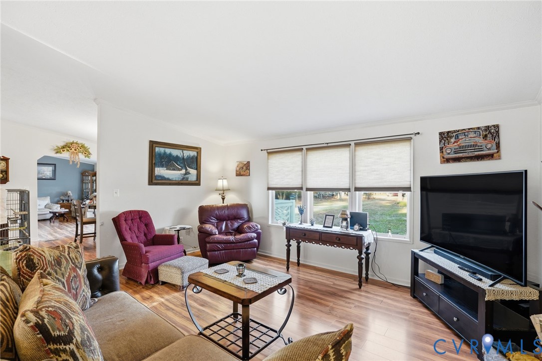 11621 Mapsico Road Charles City, VA 23030 - Photo 14 of 36 a living room with furniture a flat screen tv and a floor to ceiling window