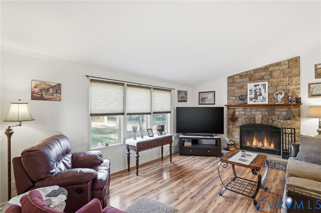 11621 Mapsico Road Charles City, VA 23030 - Photo 15 of 36 a living room with furniture a flat screen tv and a fireplace