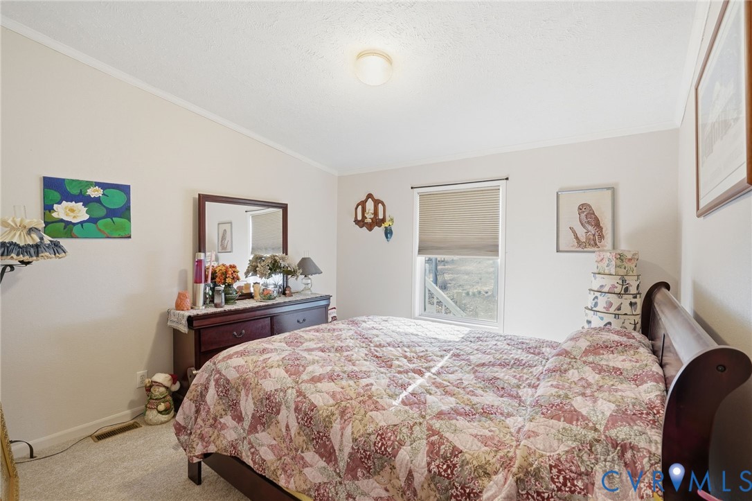 11621 Mapsico Road Charles City, VA 23030 - Photo 21 of 36 a bedroom with a bed and dresser