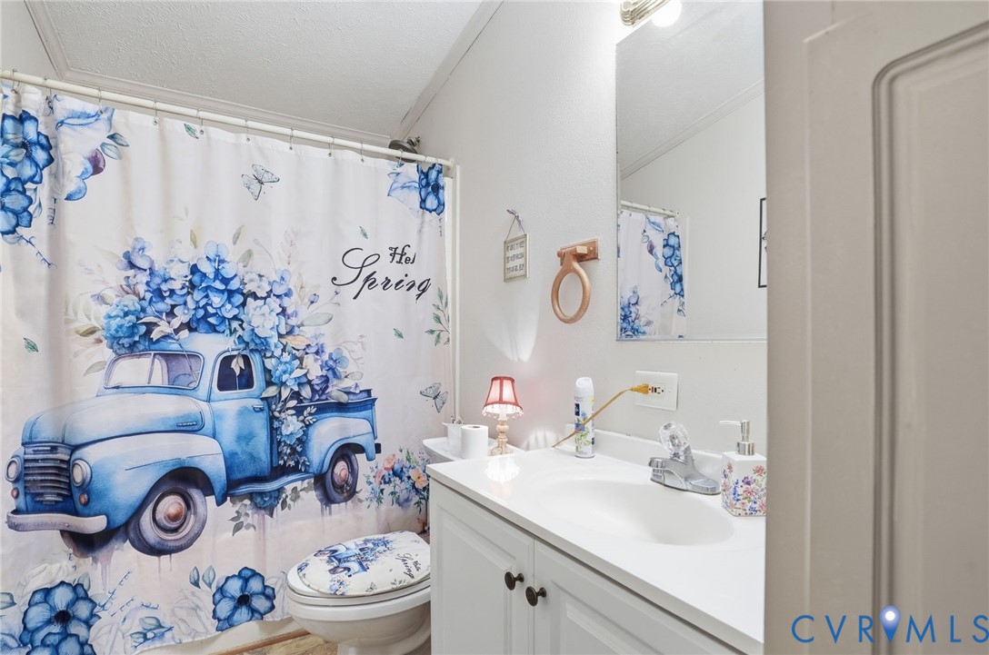 11621 Mapsico Road Charles City, VA 23030 - Photo 25 of 36 a bathroom with a sink mirror and vanity next to a window