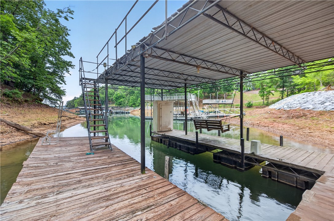 206 James Hare Road Anderson, SC 29626 - Photo 8 of 37 A well-maintained covered dock provides boat access to the tranquil lake.