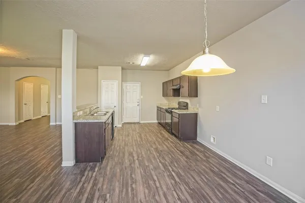 a view of a kitchen with a sink and a refrigerator