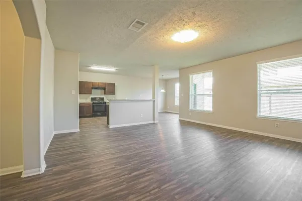 a view of a room with wooden floor