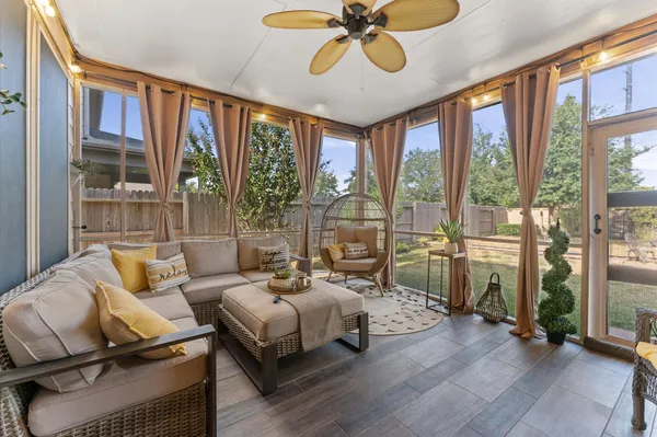a living room with furniture fireplace and a large window