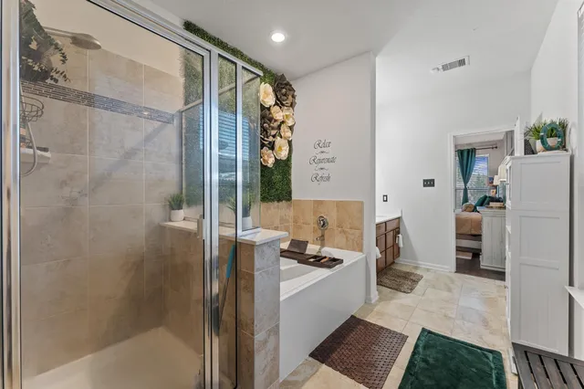 a bathroom with a bathtub and a shower