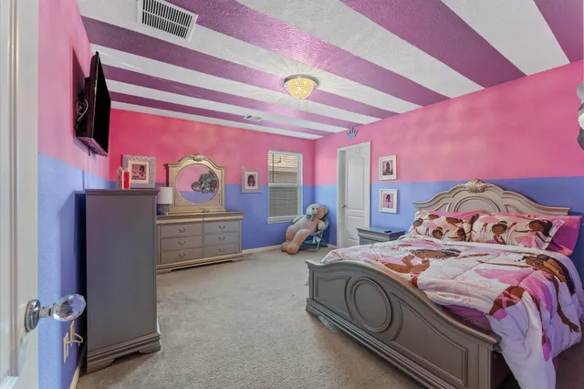 a bedroom with a bed and a dresser