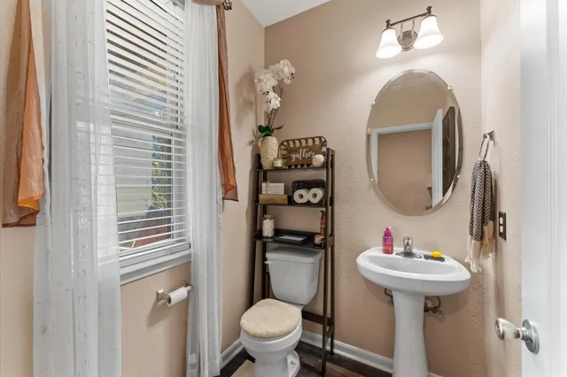 a bathroom with a toilet sink and mirror