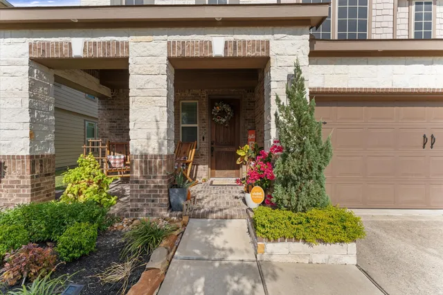 a view of a house with potted plants