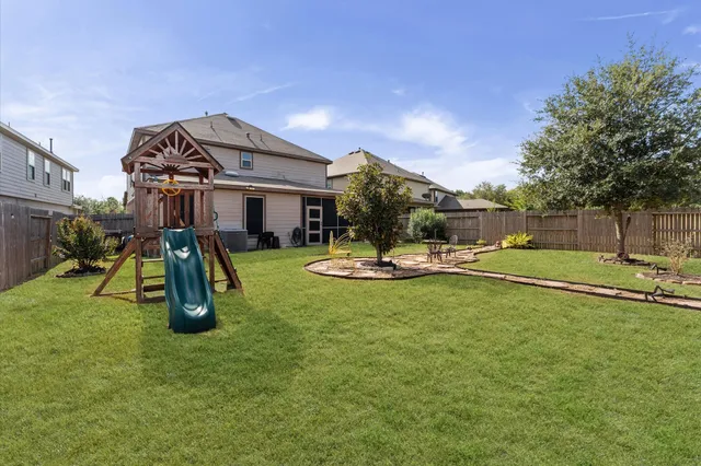 a view of a house with backyard sitting area and garden