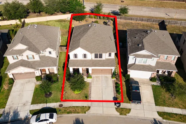 an aerial view of residential houses with outdoor space